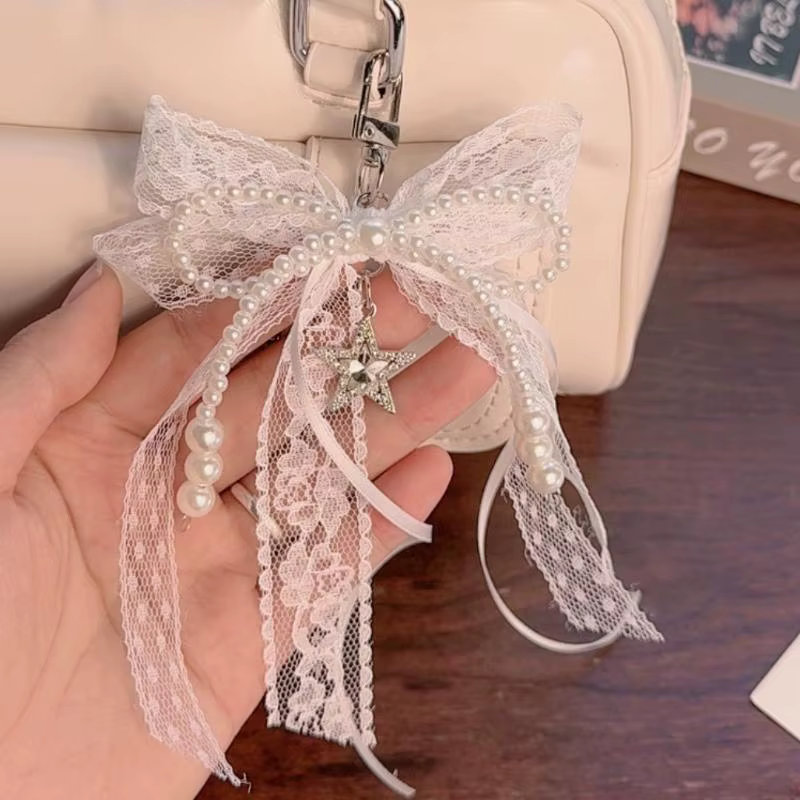 Porte-clés cadeau mignon pour la Saint-Valentin, nœud en dentelle avec chaîne de perles et breloque étoile. Accessoire de sac en ruban de ballet pour femme